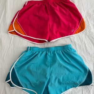 2 pairs of ASICS running shorts - both Medium; blue; pink/orange